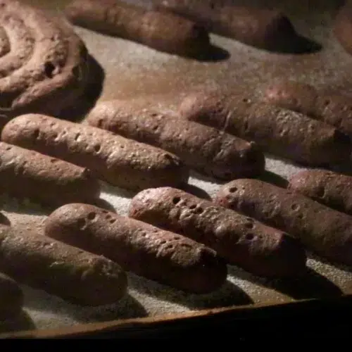 chocolate ladyfingers rising in the oven