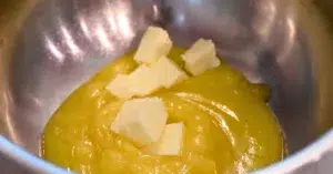 adding butter to lemon curd