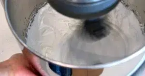 whipping heated sugar and egg white to make Swiss meringue