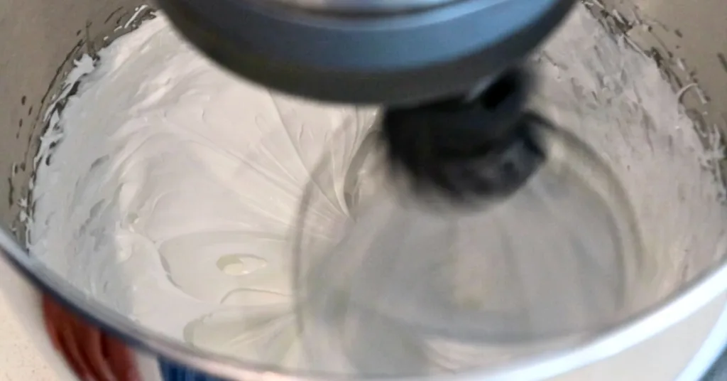 whipping sugar and egg white to make Swiss meringue