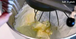 adding butter to the Swiss meringue to make Swiss buttercream