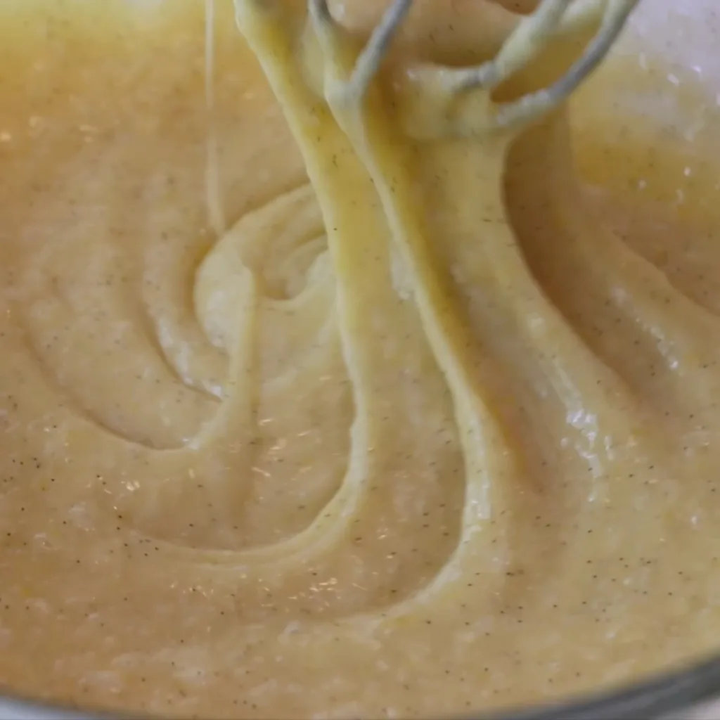 mixing flour in madeleine batter