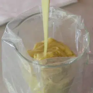 pouring madeleine batter in a pastry bag