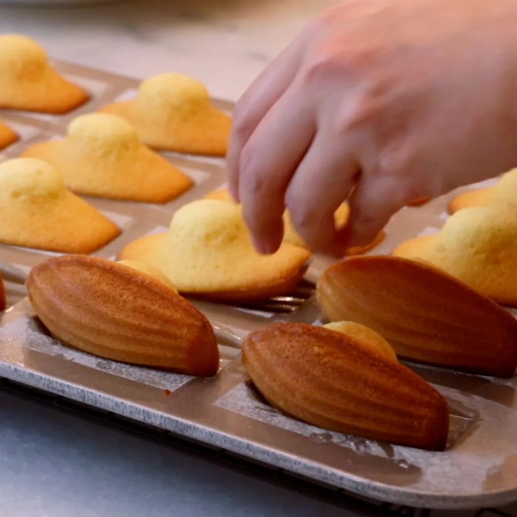 removing madeleines from a pan