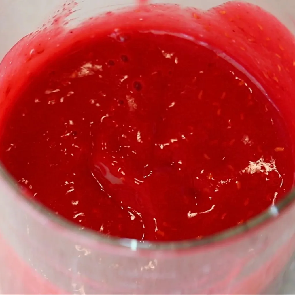 pureed raspberries in a glass cup