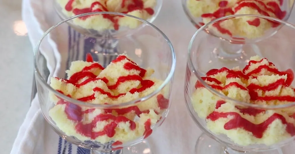 fluffy sponge pieces soaked in raspberry sauce in glass cups