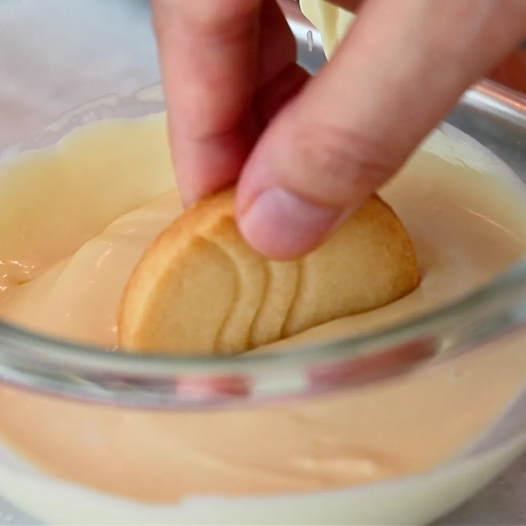 dipping shortbread cookie in white chocolate