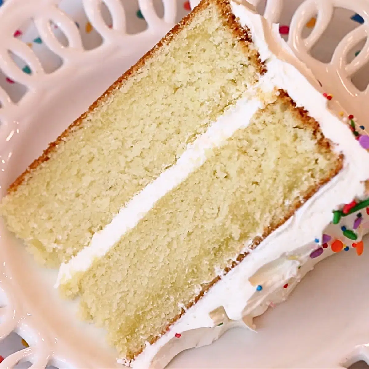 a slice of moist vanilla cake on a plate