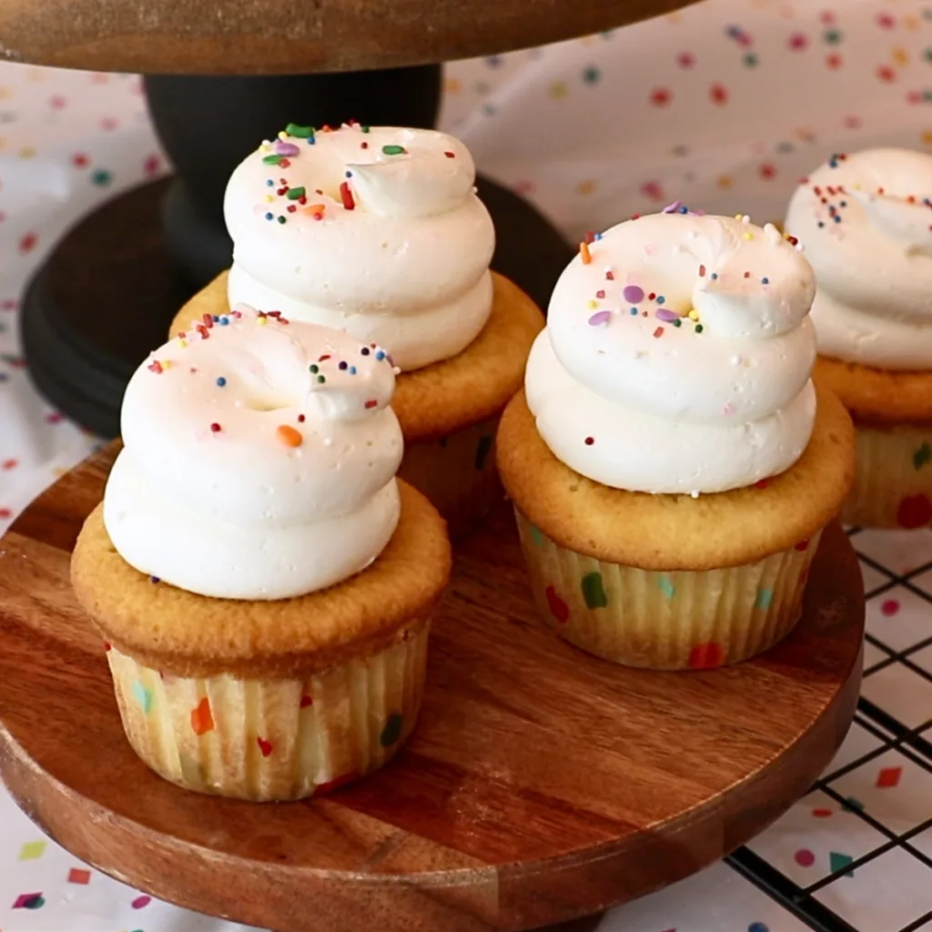 vanilla cupcakes with sprinkles on top