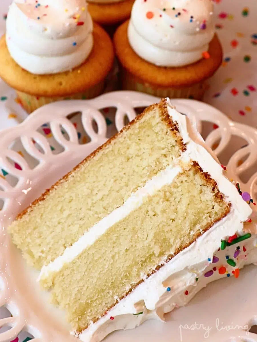 moist vanilla cupcakes and a slice of vanilla cake frosted with buttercream