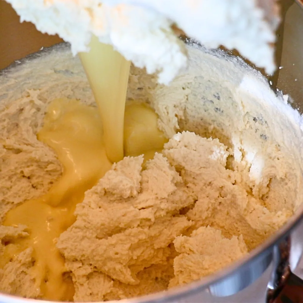 adding wet ingredients to the cake batter