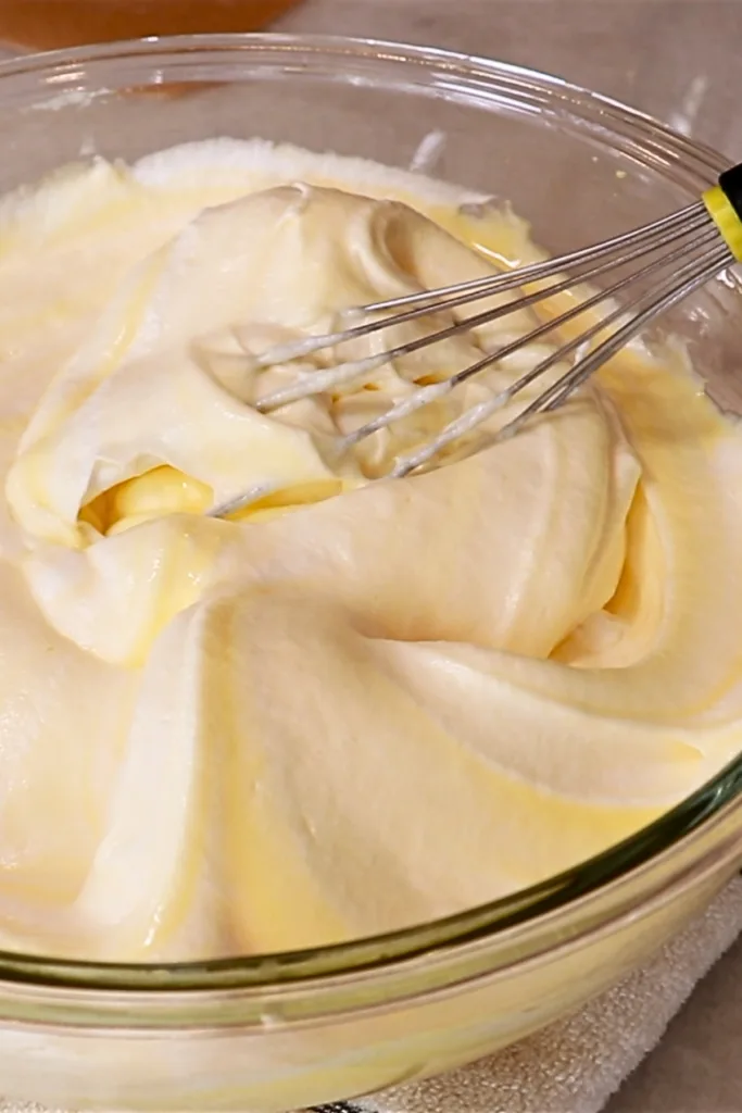 folding meringue and whipped yolks in a bowl