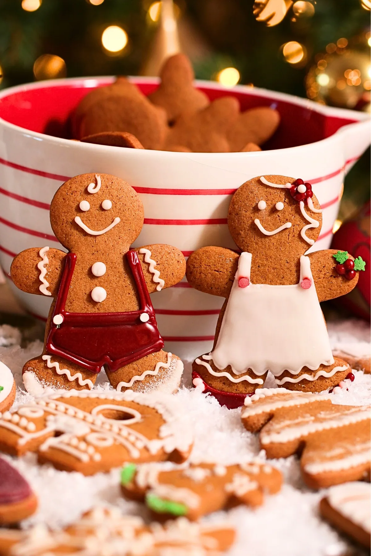 homemade gingerbread cookies decorated with loyal icing, laid on a pile of snow