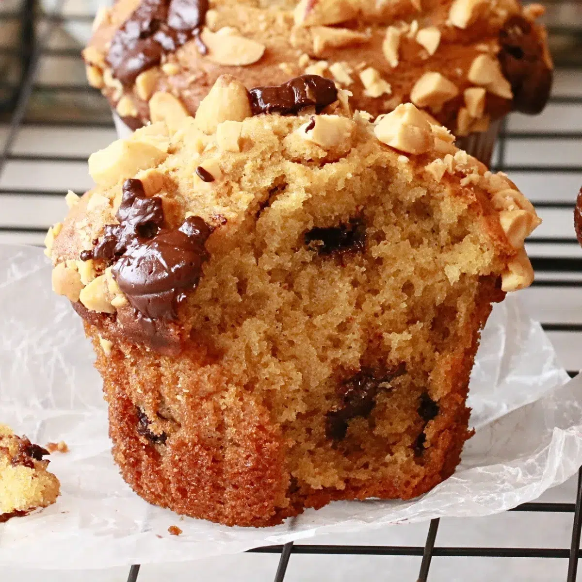 a homemade chocolate chip peanut butter muffin on a wire rack