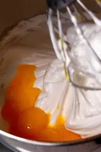 adding yolks to meringue